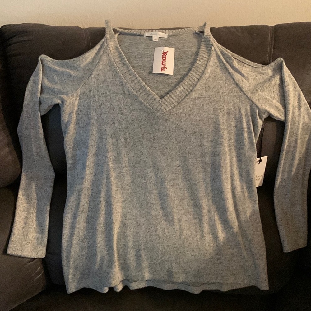 Never been worn, new with tags. Soft, shoulderless heather gray sweater.